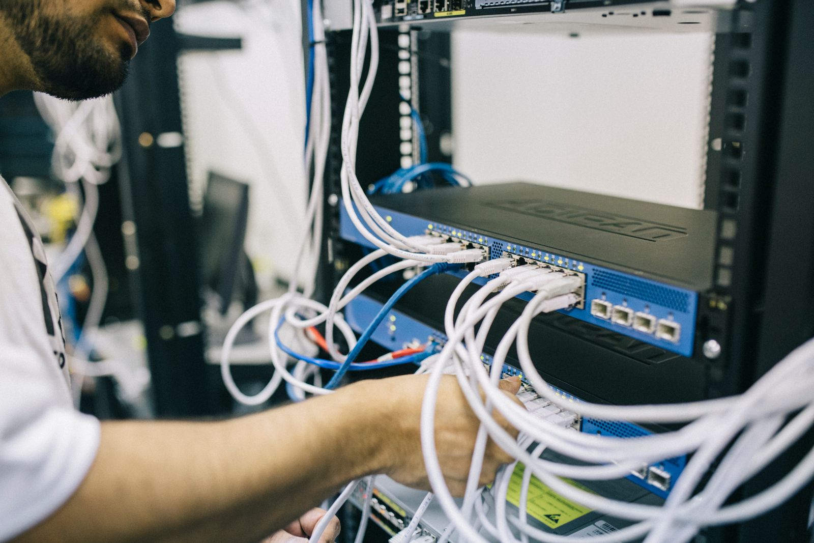 A technician working in a server cabinet